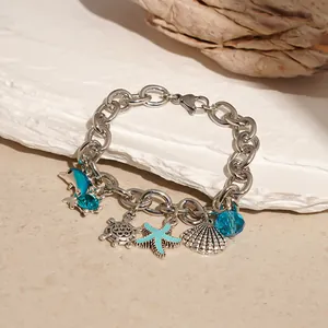 Detailed view of silver chain bracelet featuring ocean charms like starfish dolphin and seashell