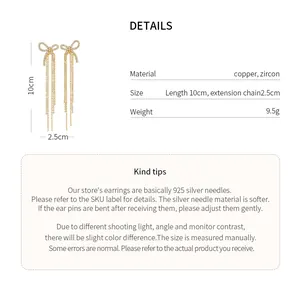 Detail view of gold bow-knot tassel earrings with dimensions and material info