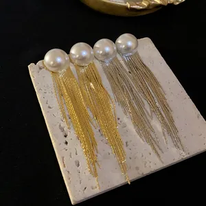 Elegant long tassel earrings featuring half-round pearls in gold and silver finish