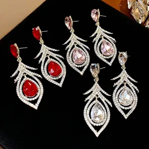 Vintage palace style hollow feather earrings with crystals in red, pink, and white.