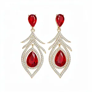 Elegant vintage gold-toned feather drop earrings with red pear-cut crystals and pavé stones.