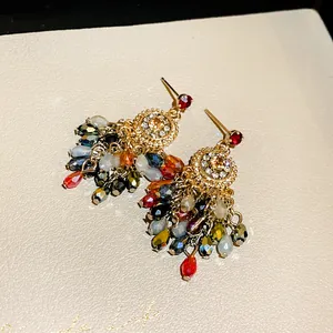 Detailed macro view of colorful crystal tassel earrings with sparkling rhinestones set.