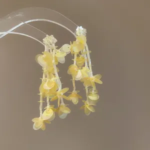 Pendientes elegantes de borla de pétalos amarillos con cuentas de vidrio