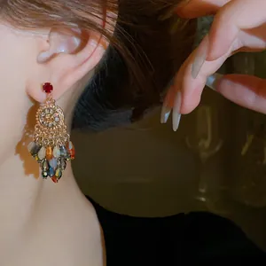 Detailed close-up of vintage flower crystal tassel earrings with colorful beads