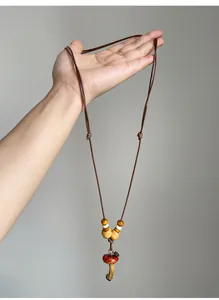 Detailed view of a handmade retro ethnic style mushroom pendant necklace with wooden beads