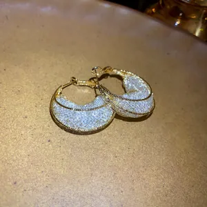 Detailed close-up of mesh moon boat earrings with gold-tone frame and silver netting inlay