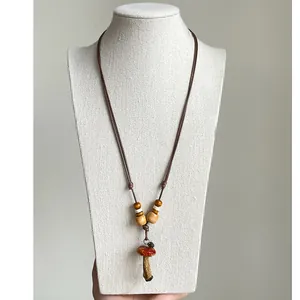 Detailed view of a retro ethnic mushroom pendant necklace featuring unique wooden beads