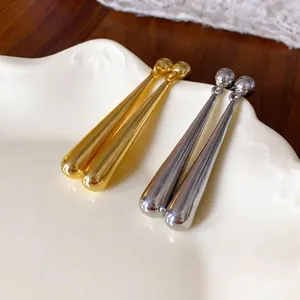Elegant gold and silver teardrop earrings with a glossy metallic finish for women.