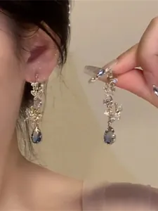 Elegant floral crystal drop earrings with blue pear-shaped stones and shimmering cubic zirconia