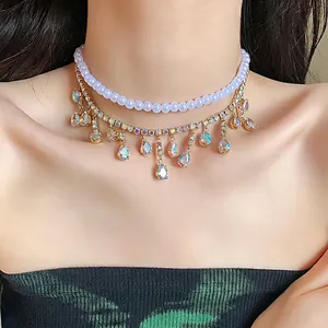 Elegant double-layered necklace featuring white pearls and sparkling rhinestone teardrop tassels