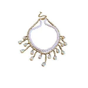 Double-layered necklace with white pearls and iridescent teardrop crystal tassels.