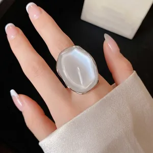 Elegant large oval pearlescent ring with a polished silver-toned metal frame