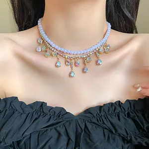 Close-up of elegant double-layer pearl necklace with iridescent teardrop zircon tassels.