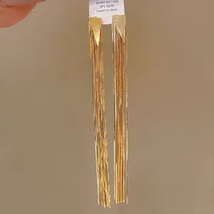 Close-up of elegant gold long tassel earrings with S925 silver needle and export tag