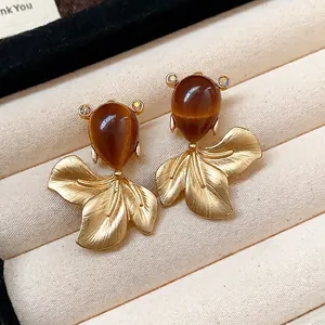 Vintage Maillard style goldfish stud earrings with brown drop resin and textured gold finish.