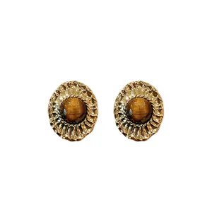 Vintage palace style oval stud earrings with tiger's eye stones and textured gold frames