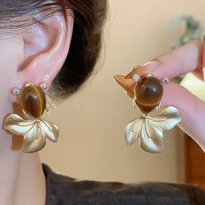 Vintage goldfish drop earrings featuring brown teardrop stones and sparkling crystal accents