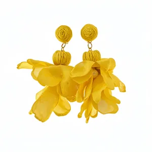 Vibrant yellow chiffon flower drop earrings with raffia rosettes and delicate pearl accents.