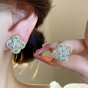 Close-up of elegant cubic zirconia flower ear clips with 18k gold plating for women