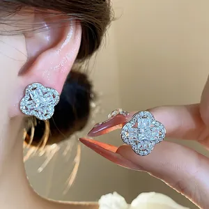 Close-up of elegant clover-shaped zircon ear clips with a brilliant silver finish