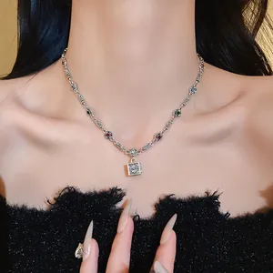 Detailed macro view of vintage silver necklace featuring a square floral pendant and colorful stones
