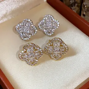 Close-up of 18k gold-plated clover ear clips with sparkling cubic zirconia stones.