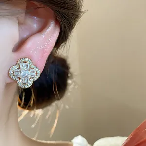 Close-up detail of 18k gold plated four-leaf clover ear clip with zircon inlay