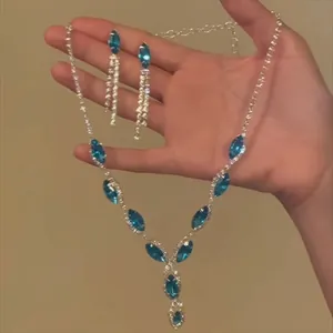 Exquisite silver-tone necklace and earring set featuring blue marquise crystals and rhinestones