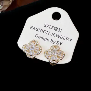 Detailed view of 18k gold plated flower ear clips with sparkling cubic zirconia stones