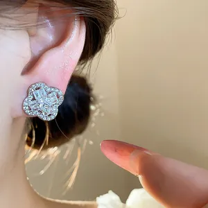 Close-up detail of 18k gold plated zircon flower ear clips for non-pierced ears