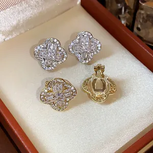 Close-up detail of 18k gold plated four-leaf clover ear clips with shimmering zircon stones