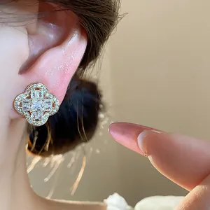 Close-up of a luxurious 18k gold plated flower ear clip with sparkling zircon stones
