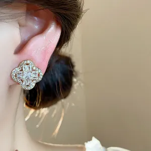 Detailed close-up of 18k gold plated flower ear clip with sparkling cubic zirconia.