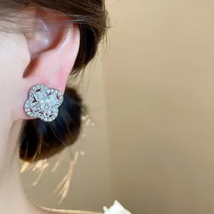 Detailed macro shot of an elegant flower ear clip with sparkling cubic zirconia stones