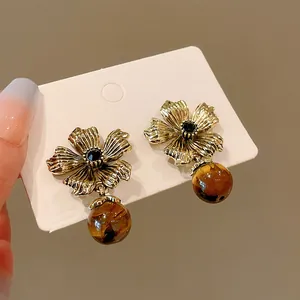 Elegant vintage gold flower earrings featuring natural tiger eye beads dangle style