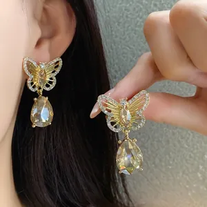 Vintage hollow butterfly earrings with champagne teardrop crystal and rhinestones.