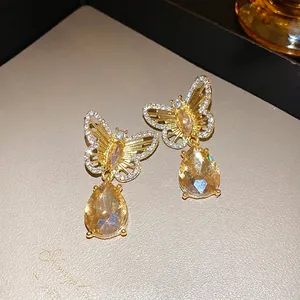 Elegant butterfly pendant earrings with sparkling rhinestones and champagne teardrop gems