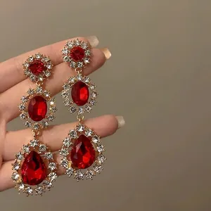Luxurious red teardrop zircon earrings with elegant sparkling flower cluster design