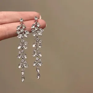 Detail shot of sparkling silver flower earrings with marquise-cut zircons