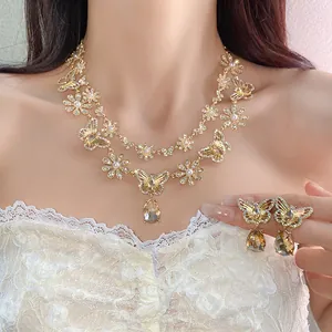 Detailed view of vintage butterfly pendant necklace and earring set with shiny crystals