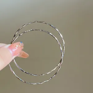 Minimalist silver hoop earrings with a textured hammered finish for everyday wear