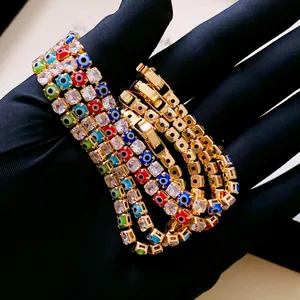 Detail of gold evil eye bracelet with square cubic zirconia and secure folding clasp