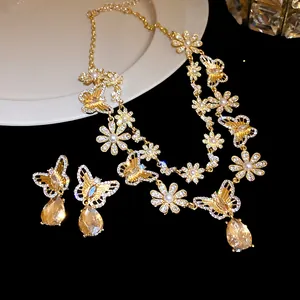 Close-up of vintage butterfly jewelry set with sparkling crystals and golden finish.