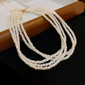 Close-up of elegant multi-layered pearl necklace with four strands and gold clasp
