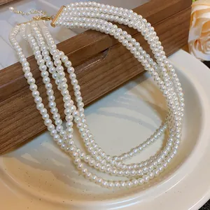 Elegant multi-layer pearl necklace with gold-toned clasp detail view