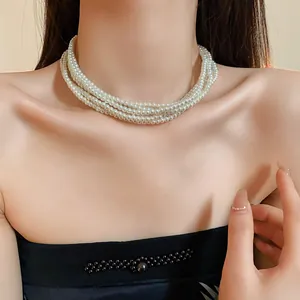 Detailed close-up of an elegant multi-layer pearl necklace choker worn by a model