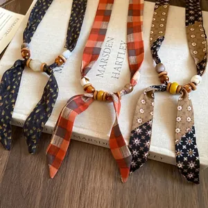 Bohemian chiffon fabric necklaces with retro wooden and ceramic beads in various patterns.