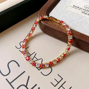Detailed macro view of the red evil eye beads and clear cubic zirconia bracelet design.