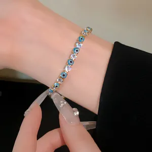 Detailed view of luxury evil eye tennis bracelet with clear cubic zirconia on wrist