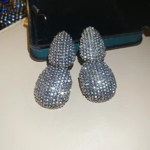 Detailed view of luxury teardrop dangle earrings with sparkling cubic zirconia stones